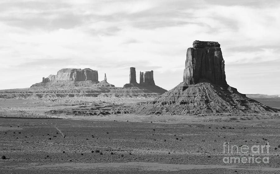 Monument Valley Arizona Sanstone Monoliths Rising Up Above Desert Floor Black and White Photograph by Shawn OBrien