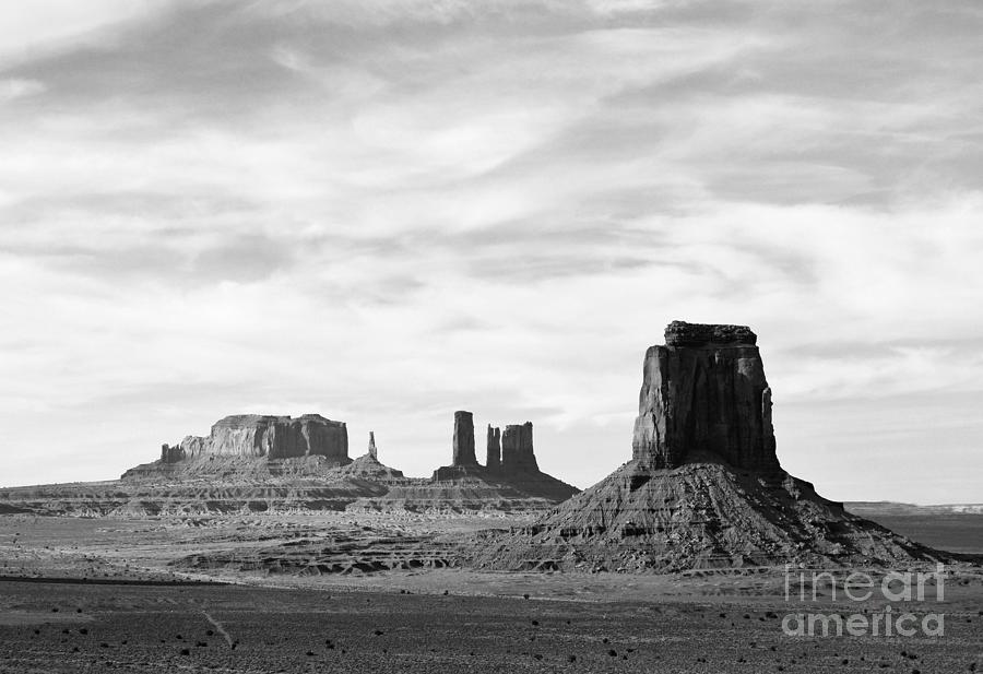 Monument Valley Utah Sanstone Monoliths Rising Up Above Desert Floor Black and White Photograph by Shawn OBrien