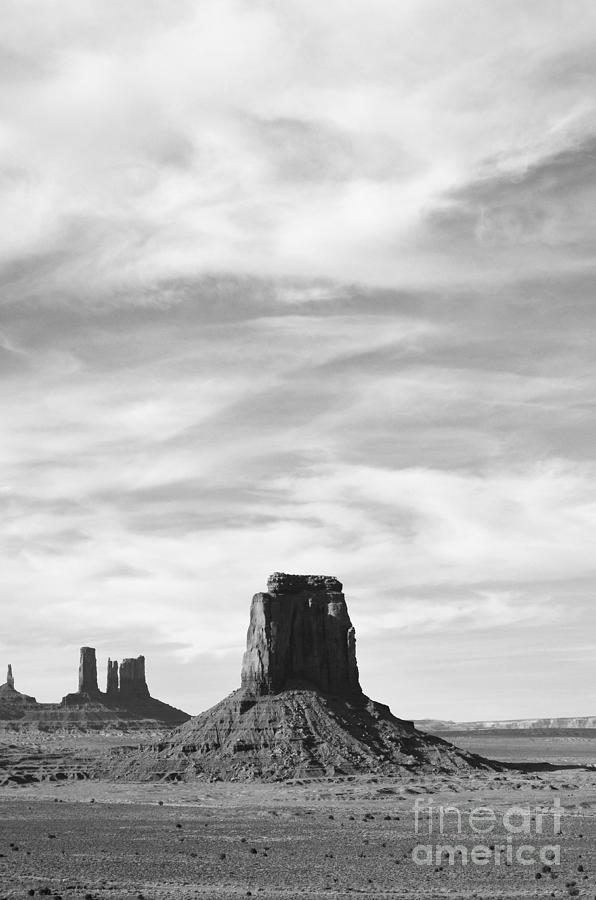 Monument Valley Utah Sandstone Monoliths Rising Up Above Desert Floor Vertical Black and White Photograph by Shawn OBrien