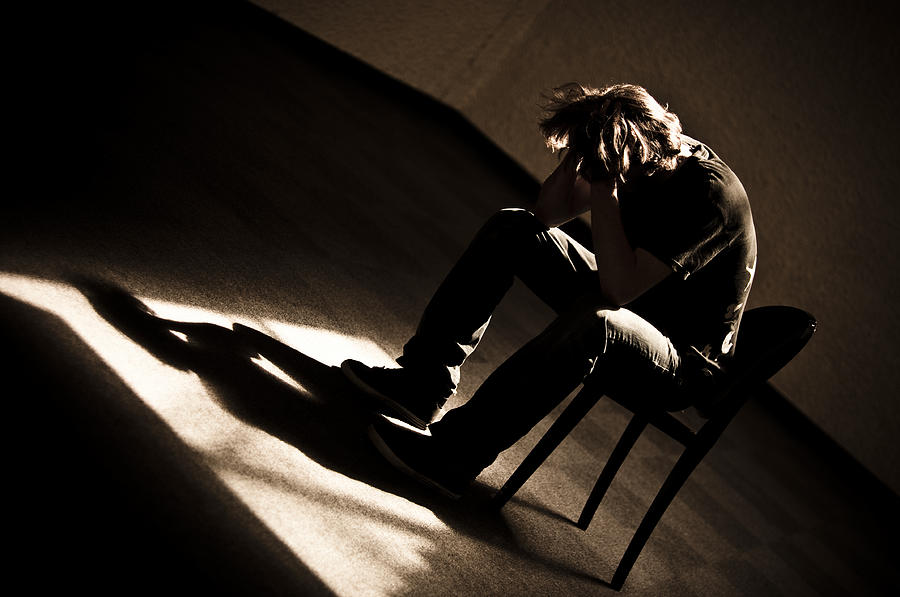 Moody monotone shot of a depressed person slumped in chair Photograph by Aurumarcus Moody monotone shot of a depressed person slumped in chair Photograph by Aurumarcus