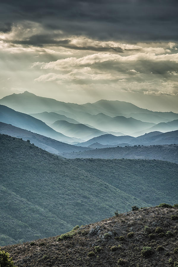 Moody skies over mountains in Balagne region of Corsica Photograph by Jon Ingall