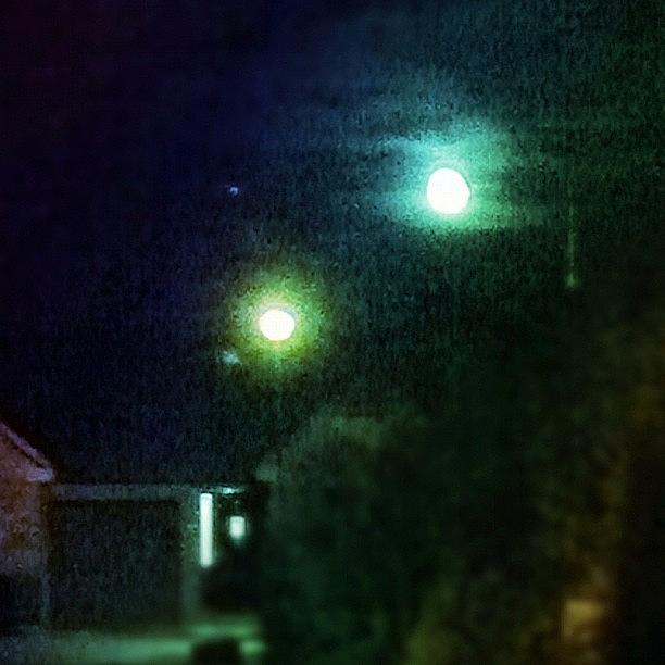 Night Photograph - Moon And Streetlamp Talking by Urbane Alien