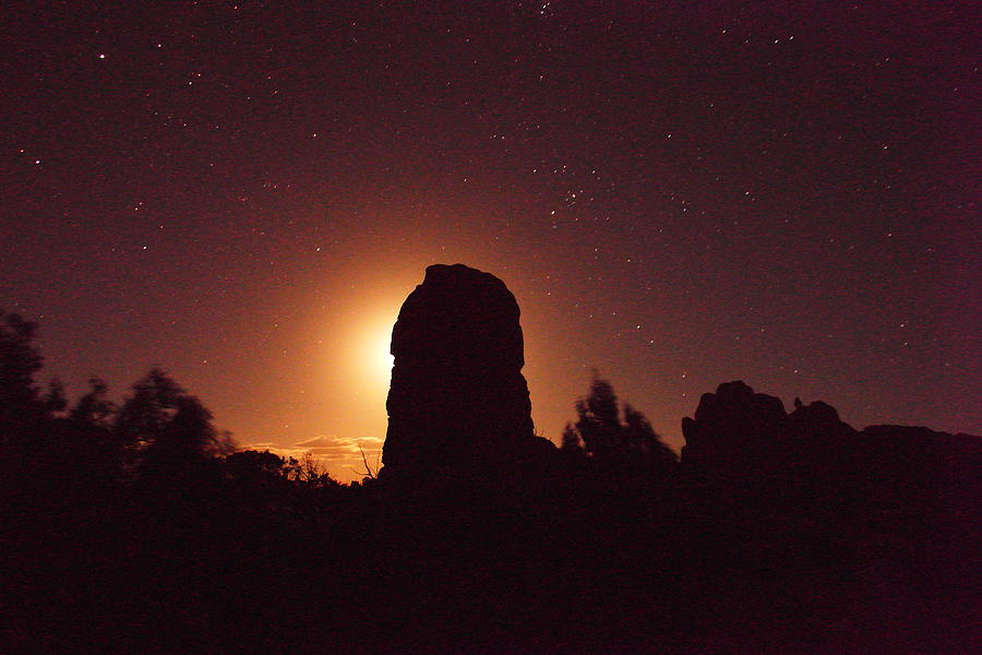 Moon behind the rock Photograph by Jeff Swan
