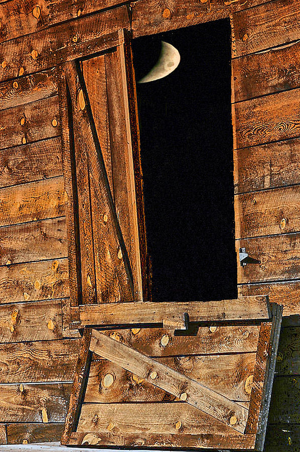 Moon through the barn door Photograph by Perry Frantzman
