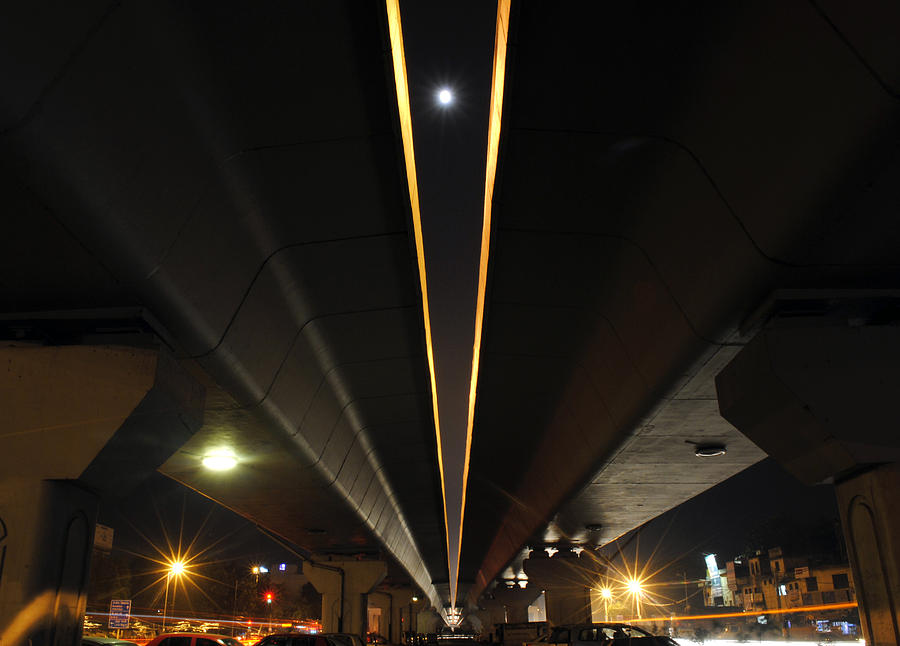 Moon visible between the flyover gap Photograph by Sumit Mehndiratta