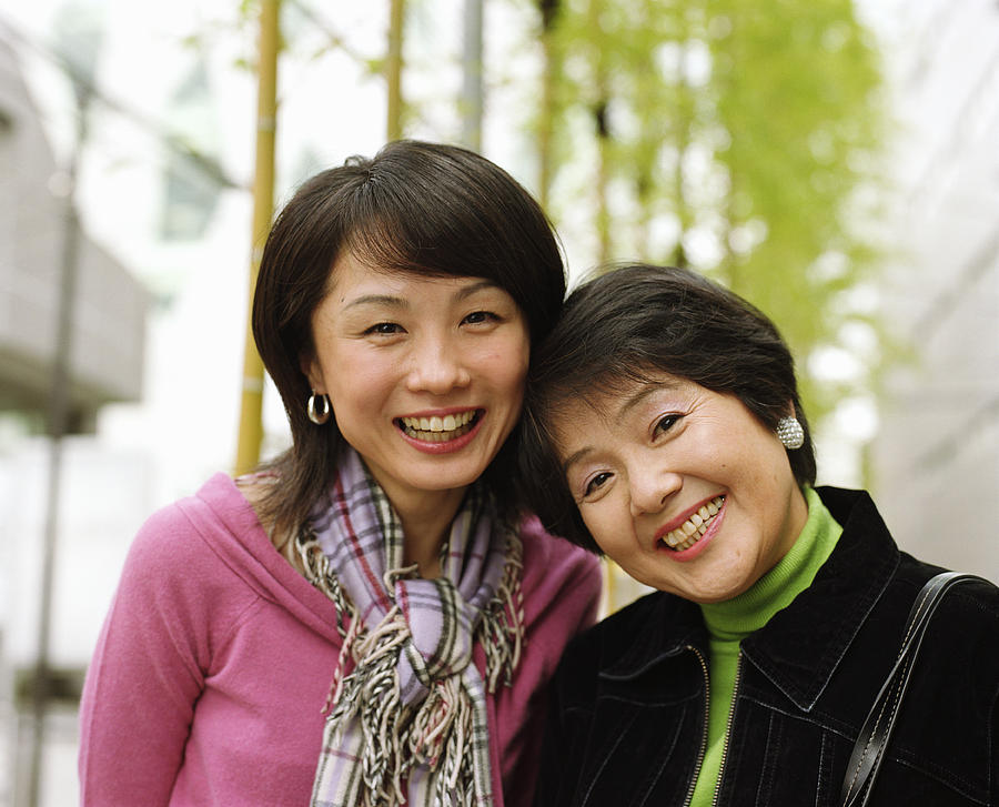 Mother and adult daughter smiling, portrait Photograph by Ryan McVay
