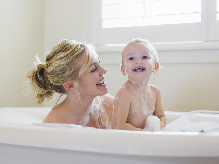Mother And Baby Taking A Bubble Bath Photograph by RubberBall Productions