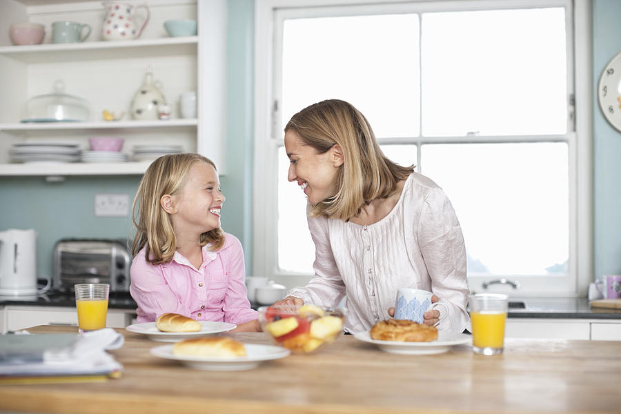 Mother and daughter having breakfast Photograph by Compassionate Eye Foundation/Rob Daly/OJO Images Ltd