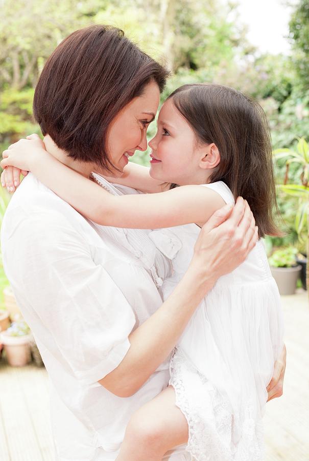 Portrait Photograph - Mother And Daughter Hugging by Ian Hooton