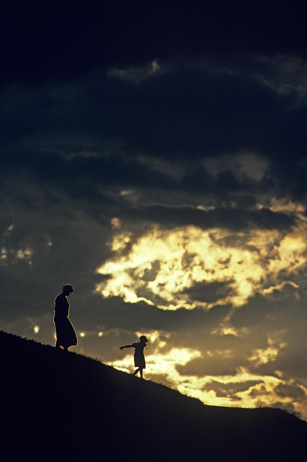 Mother and Daughter Silhouetted on Hillside Photograph by Jim Corwin