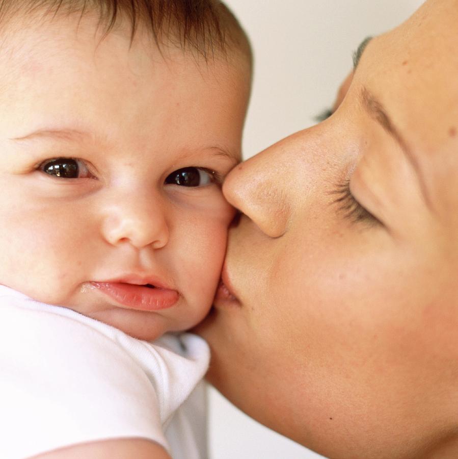 Mother Kissing Baby Girl Photograph by Ian Hooton/science Photo Library