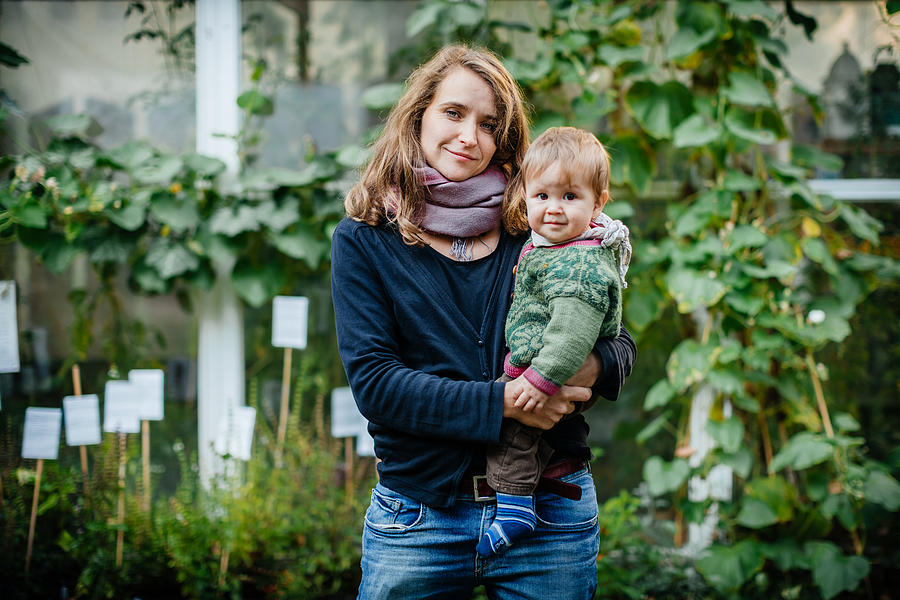 Mother with her child standing in community garden Photograph by Tom Werner