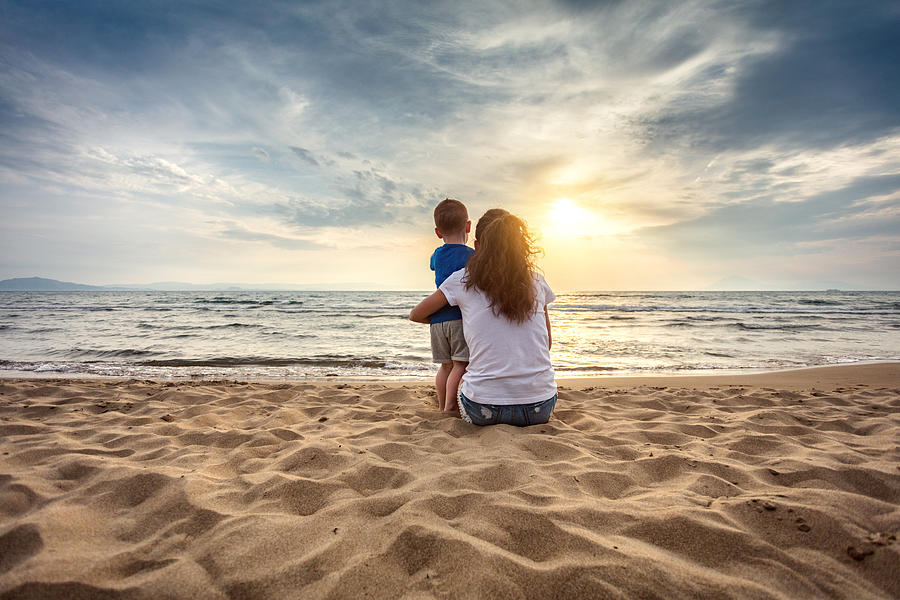 Mother with son enjoying sunset on the beach Photograph by Sankai