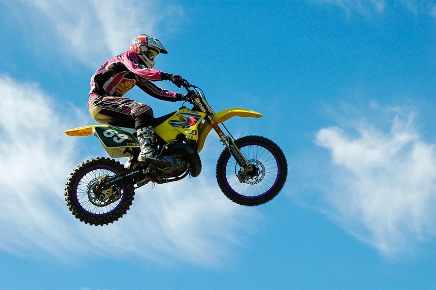 Motocross rider jumping high - blue sky Photograph by Matthias Hauser