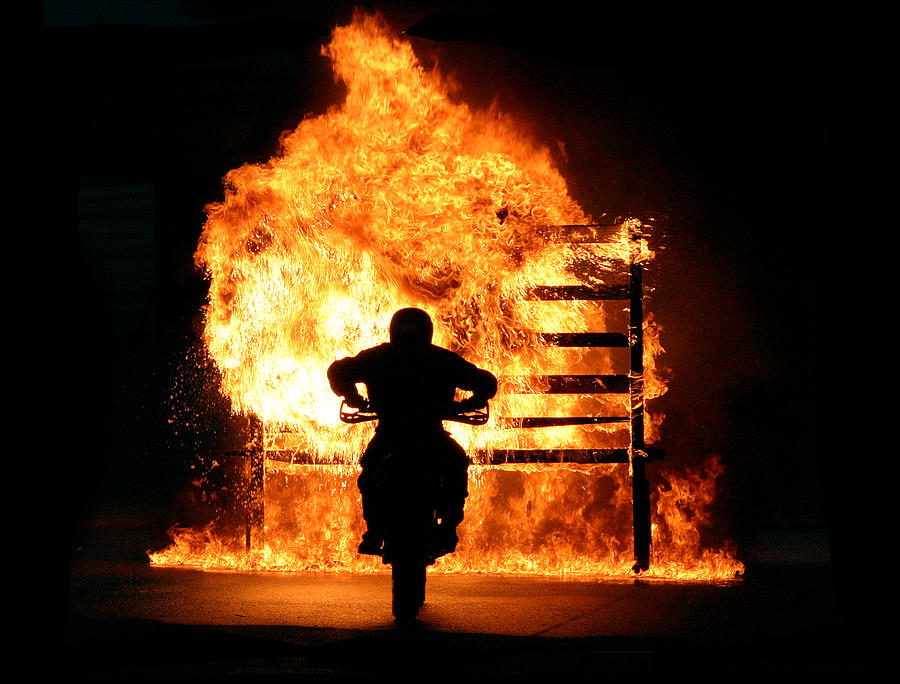Motorbike driving through wall of fire Photograph by Visual7
