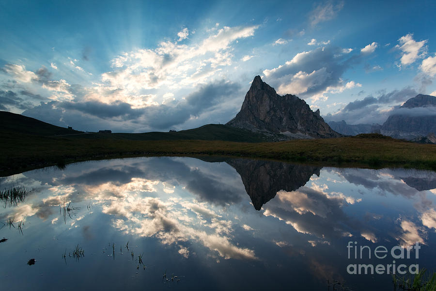Mountain peak and clouds reflected in alpine lake in the Dolomit Photograph by Matteo Colombo