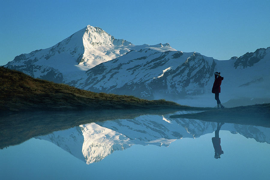 Mt Aspiring And Hiker Reflected In Lake Photograph by Colin Monteath