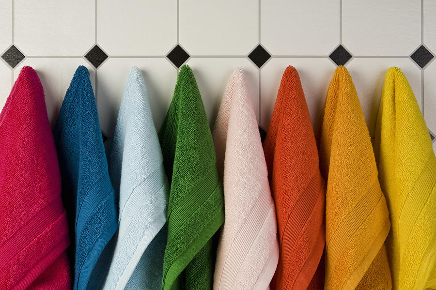 Multi colored towels hanging in a row on the wall Photograph by Caspar Benson Multi colored towels hanging in a row on the wall Photograph by Caspar Benson