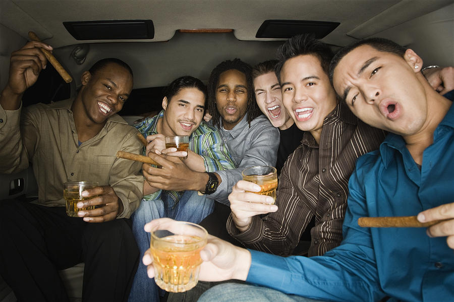 Multi-ethnic men celebrating in limousine Photograph by Hill Street Studios