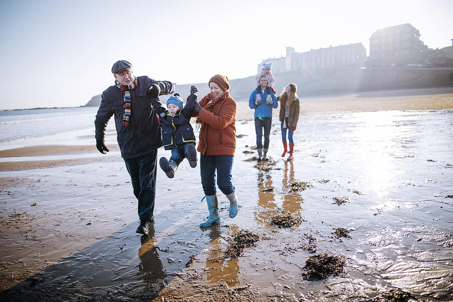 Multi- Generation Family Walking Along the Beach Photograph by SolStock