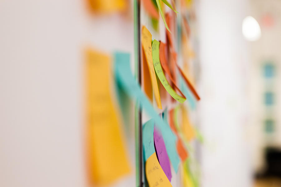 Multicolored sticky notes on whiteboard Photograph by Evgeny Tchebotarev