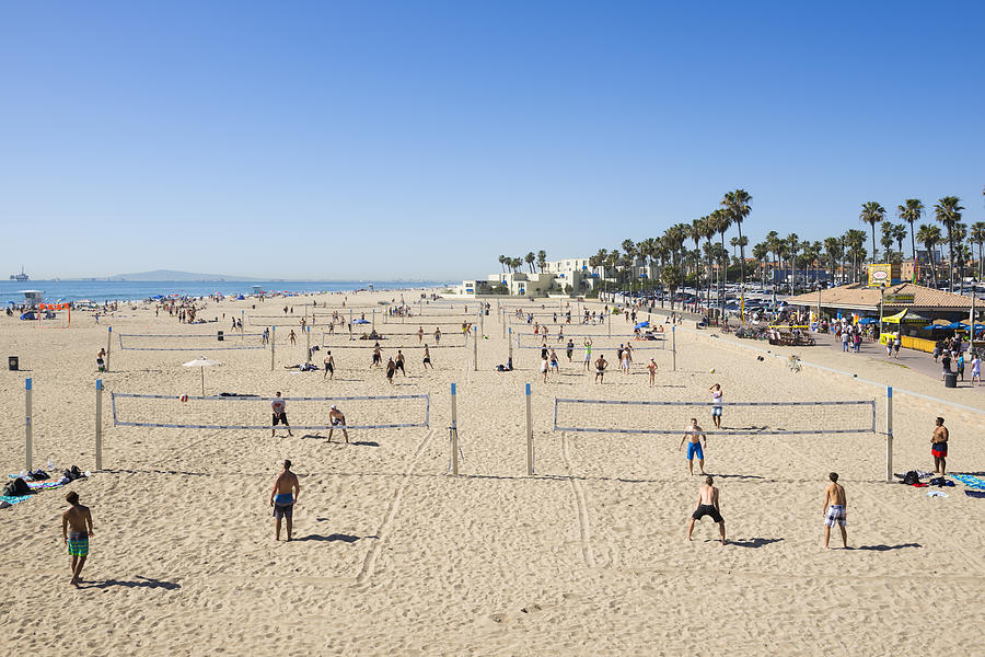 Multiple games of beach volleyball at Huntington Beach, California Photograph by Joel Carillet