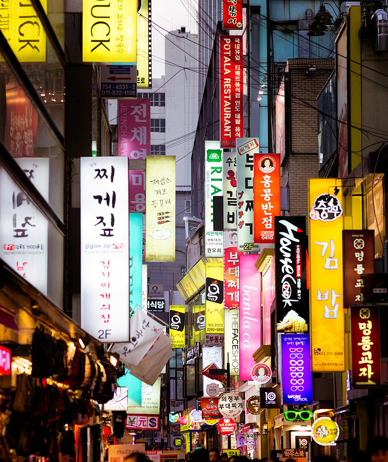 Multiple illuminated commercial signs in Seoul street at dusk Photograph by NicolasMcComber