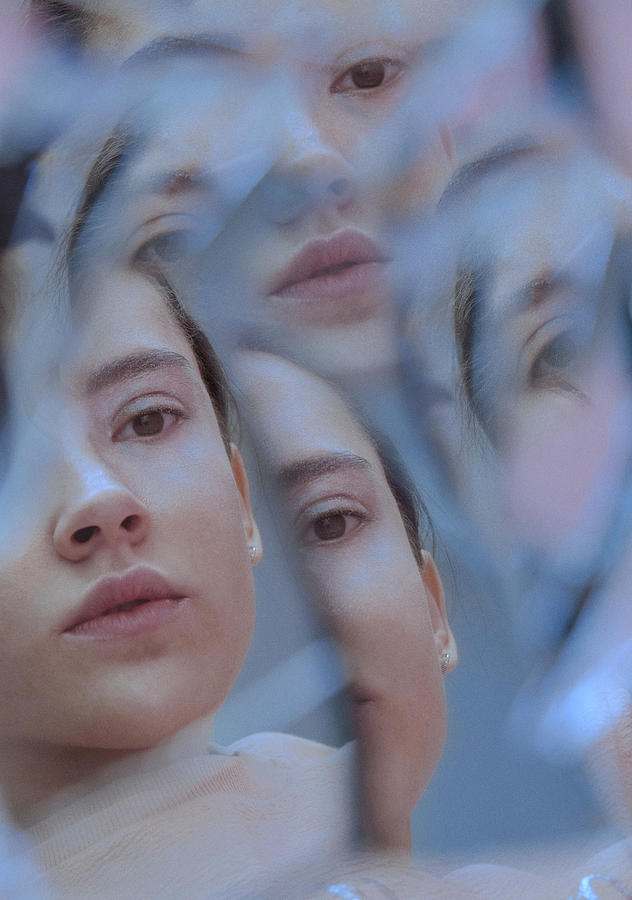 Multiple reflection of female face in broken mirror Photograph by Nina Sinitskaya