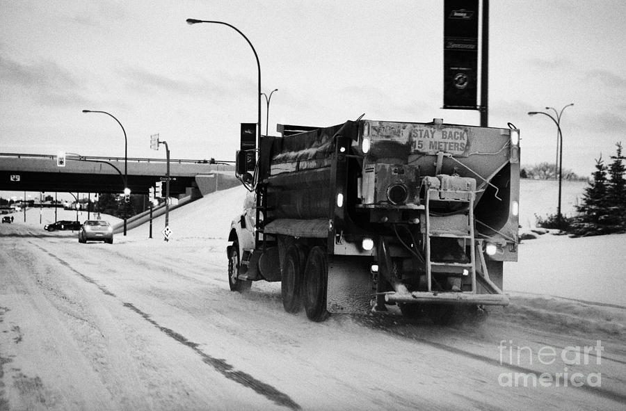 Winter Photograph - municipal city truck spreading grit and salt on roads in Saskatoon Saskatchewan Canada by Joe Fox