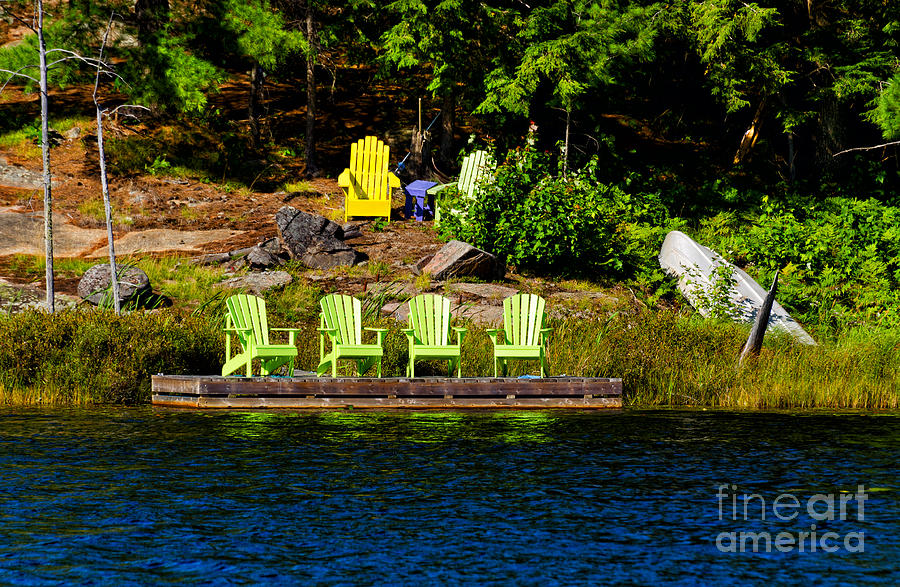 Muskoka chairs on a wooden dock Photograph by Les Palenik