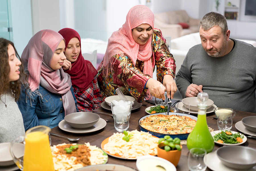 Muslim family gathering for Iftar food in Ramadan Photograph by Jasmin Merdan