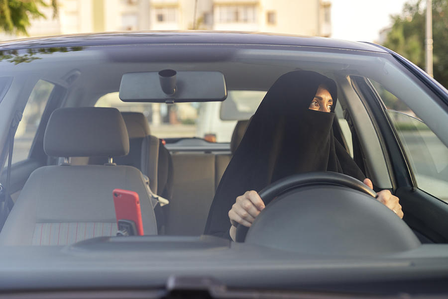 Muslim woman driving a car Photograph by Brightstars