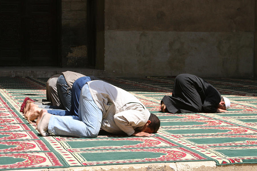 Muslims Praying in a mosque in Cairo, Egypt. Photograph by Kharps