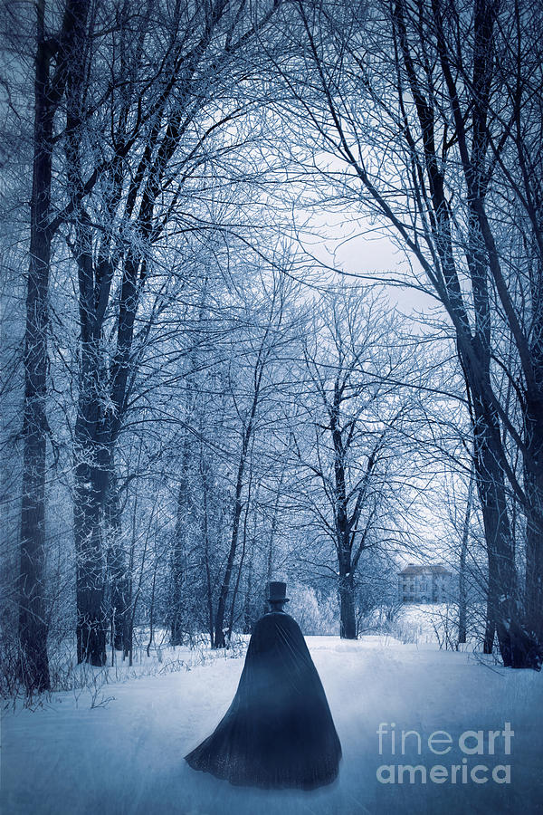 Mysterious man with cape walking through the snow Photograph by Sandra Cunningham