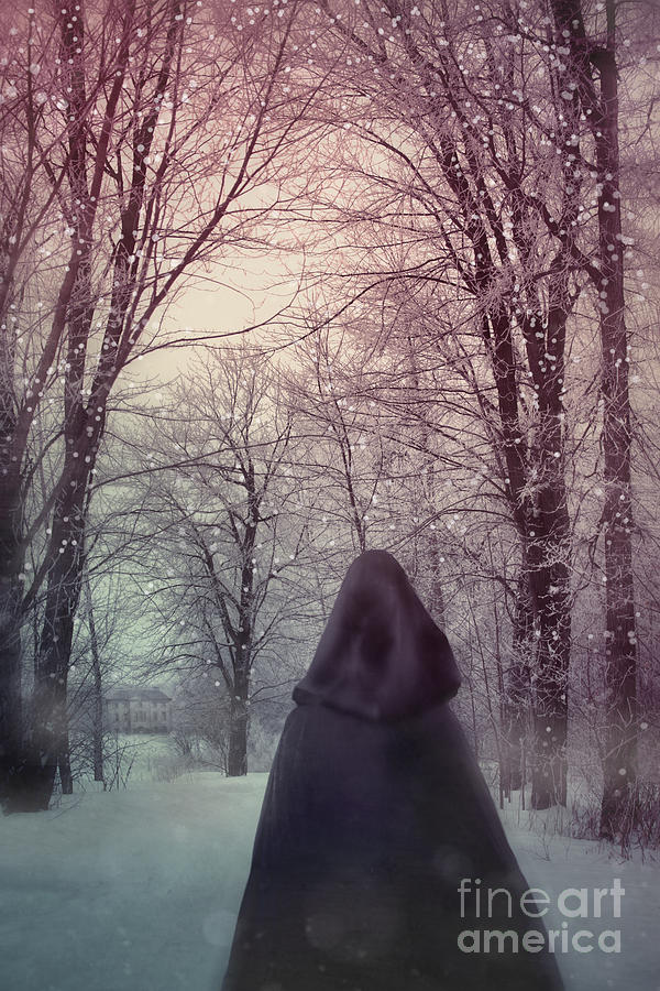 Mysterious Woman wearing cloak walking in snow Photograph by Sandra Cunningham