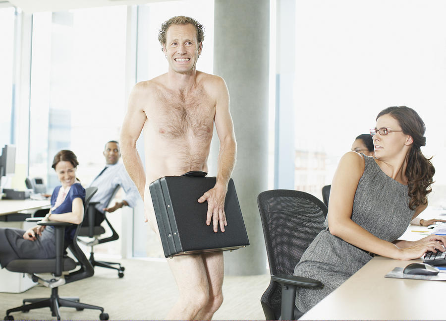Naked businessman with briefcase in office Photograph by Paul Bradbury