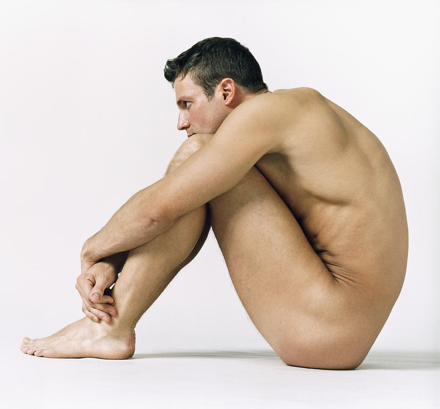 Naked Man Sitting Down With His Arms Around His Knees Photograph by Digital Vision.
