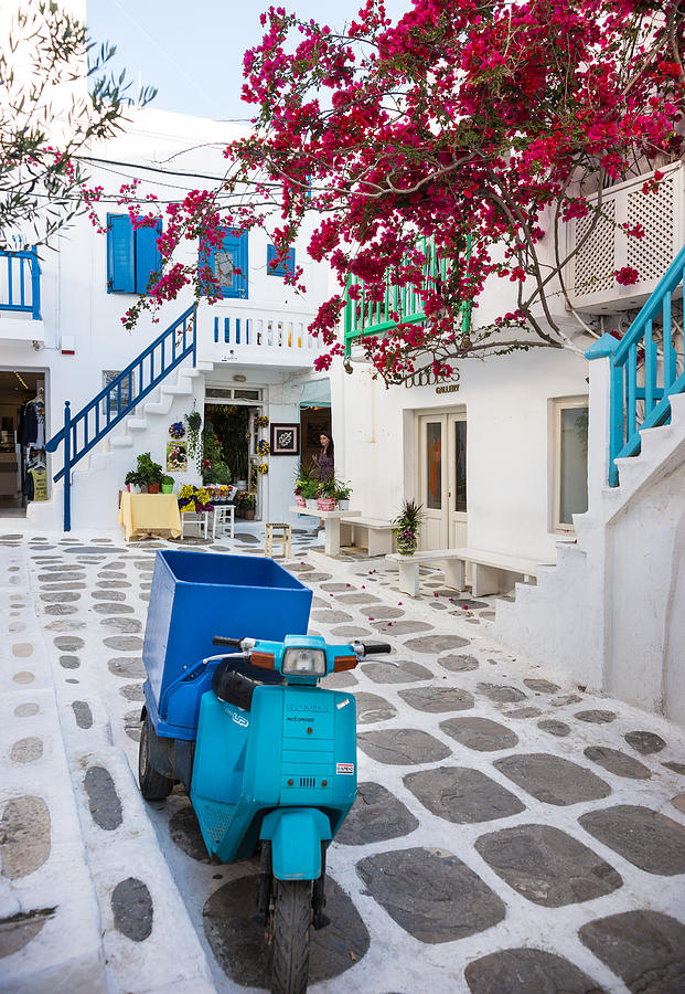 Narrow Street in Mykonos Town with Blue Motorbike and Bougainvillea Flowers Photograph by Miralex