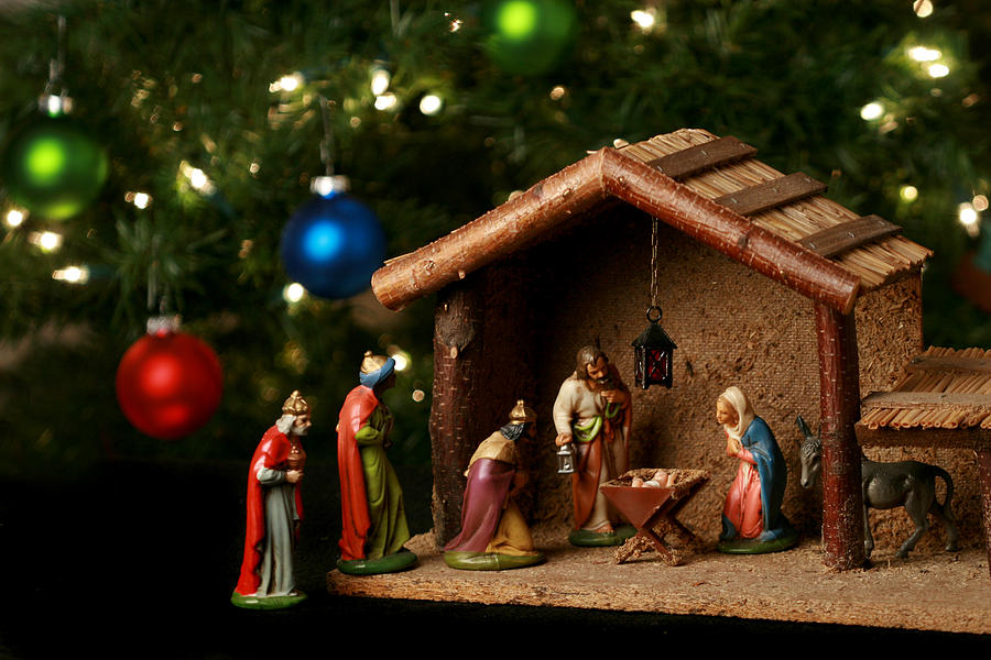 Nativity scene next to a Christmas tree Photograph by Huronphoto