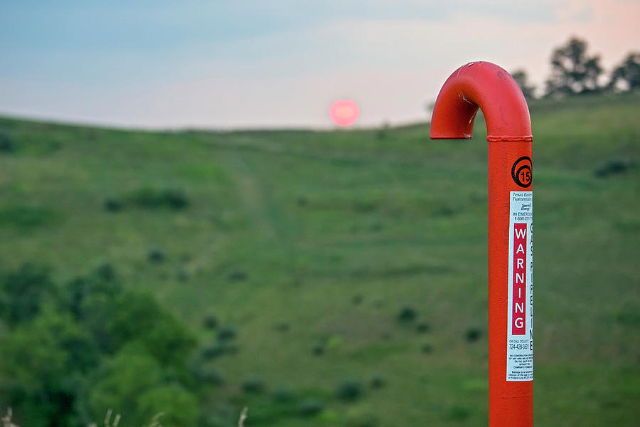 Sunset Photograph - Natural Gas Pipeline Marker At Sunset by Jim West