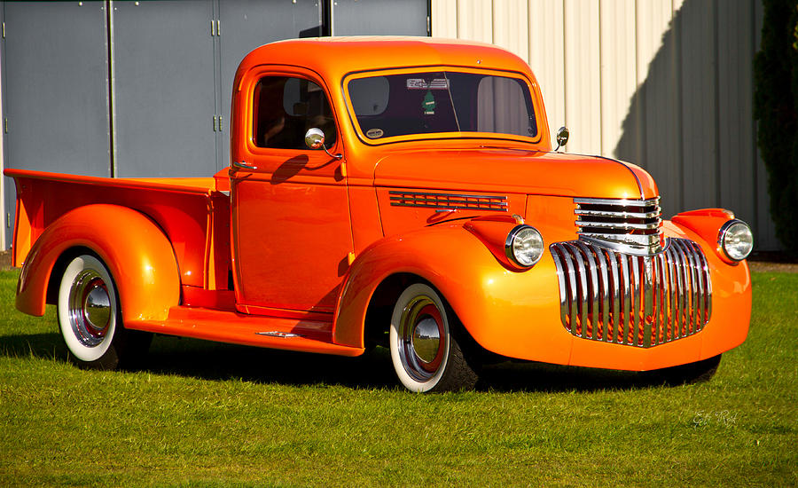 Up Movie Photograph - Neat vintage Chevrolet truck in bright orange by Eti Reid