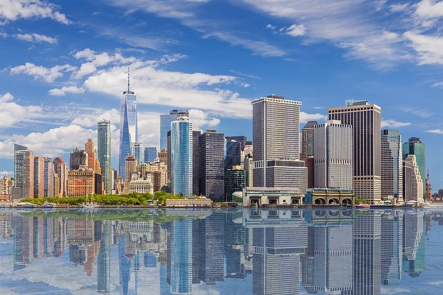 New York City Skyline with Manhattan Financial District and World Trade Center Reflected in Water of New York Harbor, NY, USA. Photograph by OlegAlbinsky