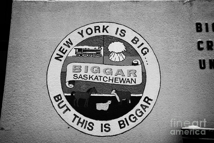 Winter Photograph - new york is big but this is biggar slogan sign Biggar Saskatchewan Canada by Joe Fox