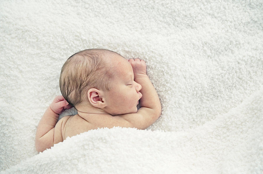 Newborn baby sleeping under blanket Photograph by Elisabeth Schmitt
