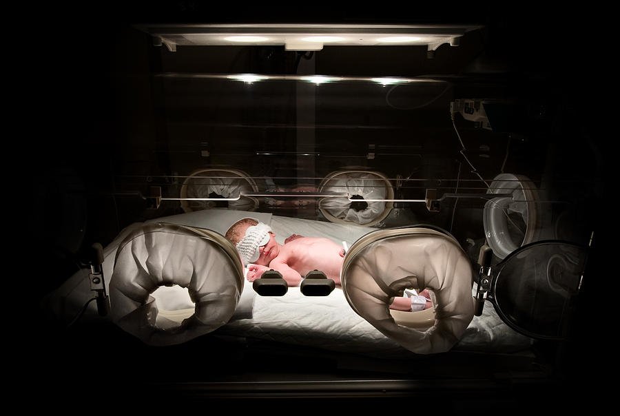 Newborn in incubator, low key Photograph by Inakiantonana