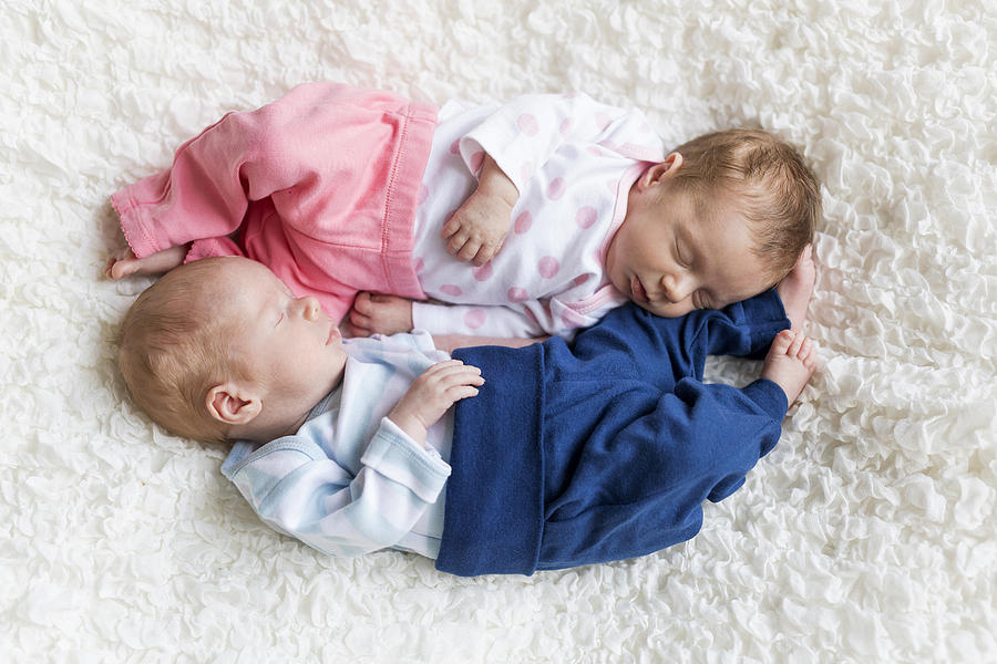 Newborn twins sleeping on white blanket Photograph by Westend61