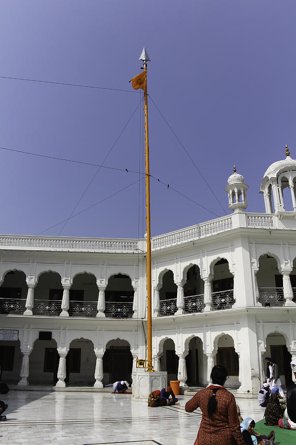 Nishan Sahib behind the Akal Takht in the Golden Temple Photograph by ...