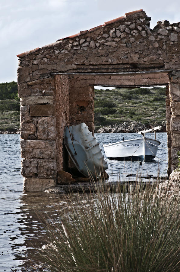 Vintage boat framed in nature of Minorca island - Hide and seek Photograph by Pedro Cardona Llambias