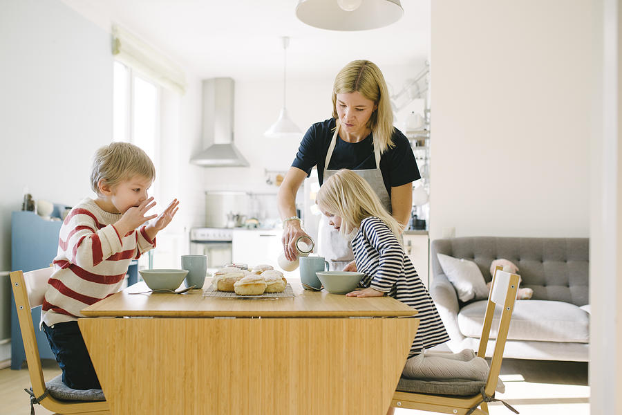 Nordic family eating semla buns on Shrove Tuesday Photograph by Visualspace
