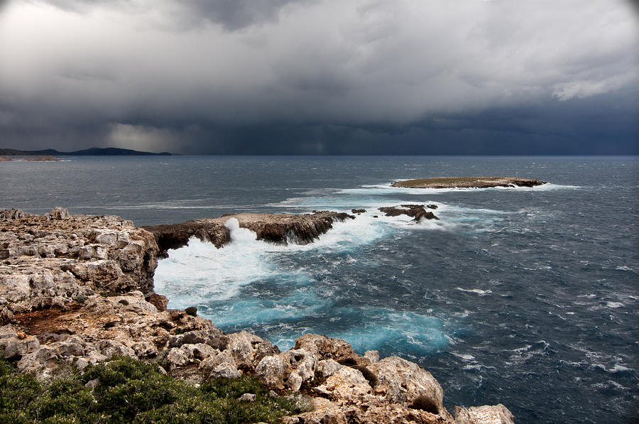 Wild Rocks at North coast of Minorca in middle of a wild sea with stormy clouds Photograph by Pedro Cardona Llambias